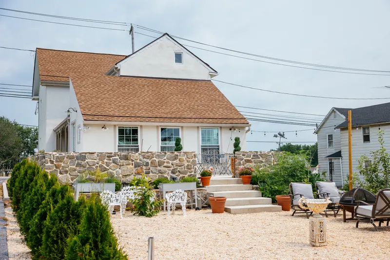 The terrace — a stone patio with chairs, looking out over the garden.