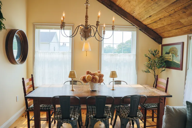 The dining room — a long table laid under a window.