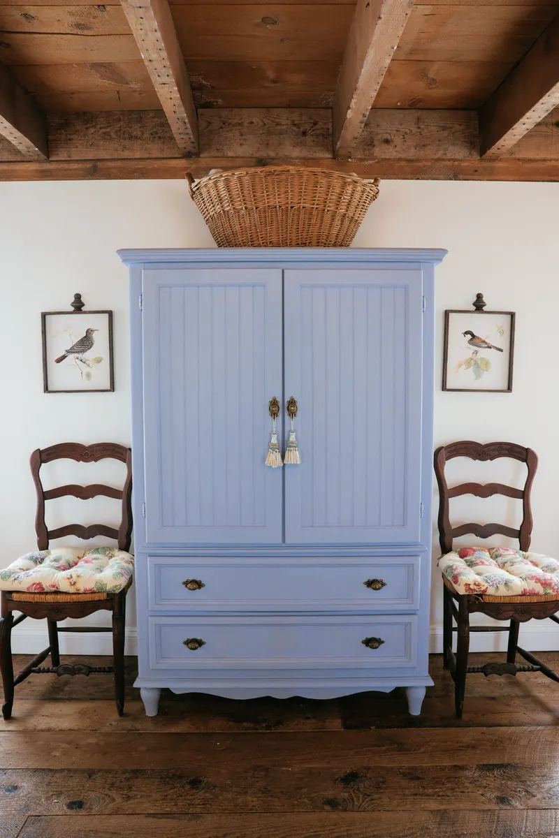 Provence — the bed made up in white linen beneath a beamed ceiling.