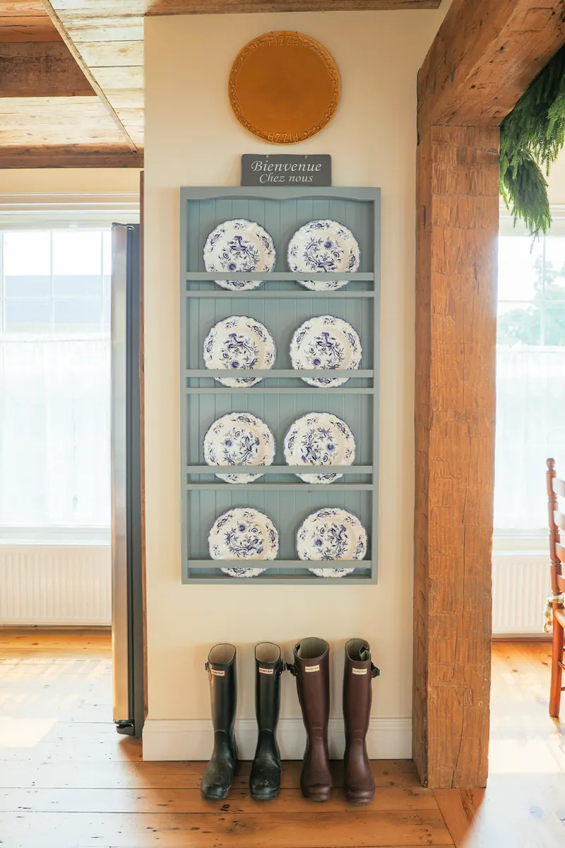 Hand-painted plates stacked on an open shelf.